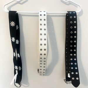 3 belts a black, white, and flower print belt